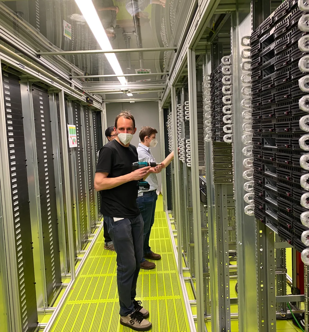 RCC team members installing and checking equipment inside the cluster racks